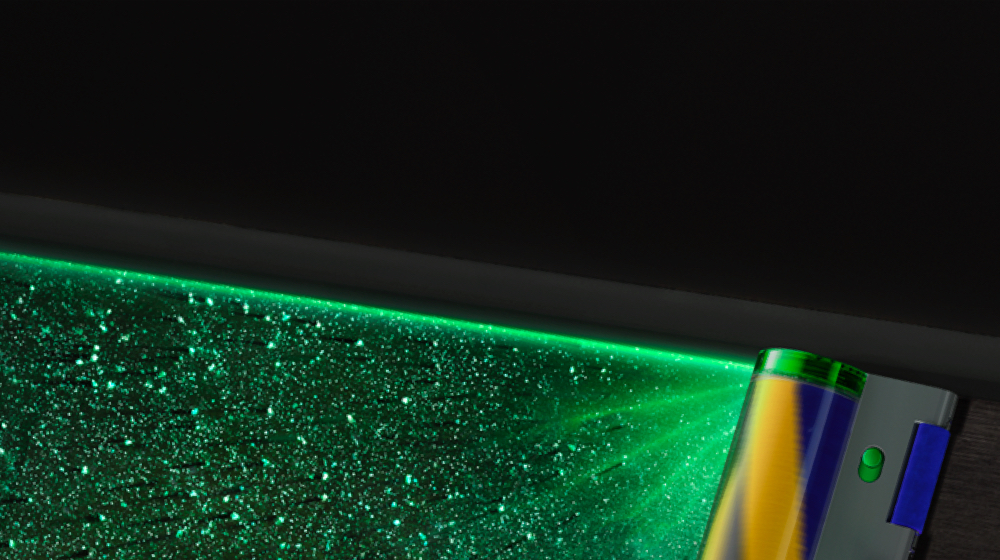 Close-up of green laser highlighting hidden dust