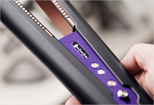 Professional stylist using a Dyson Corrale hair straightener 